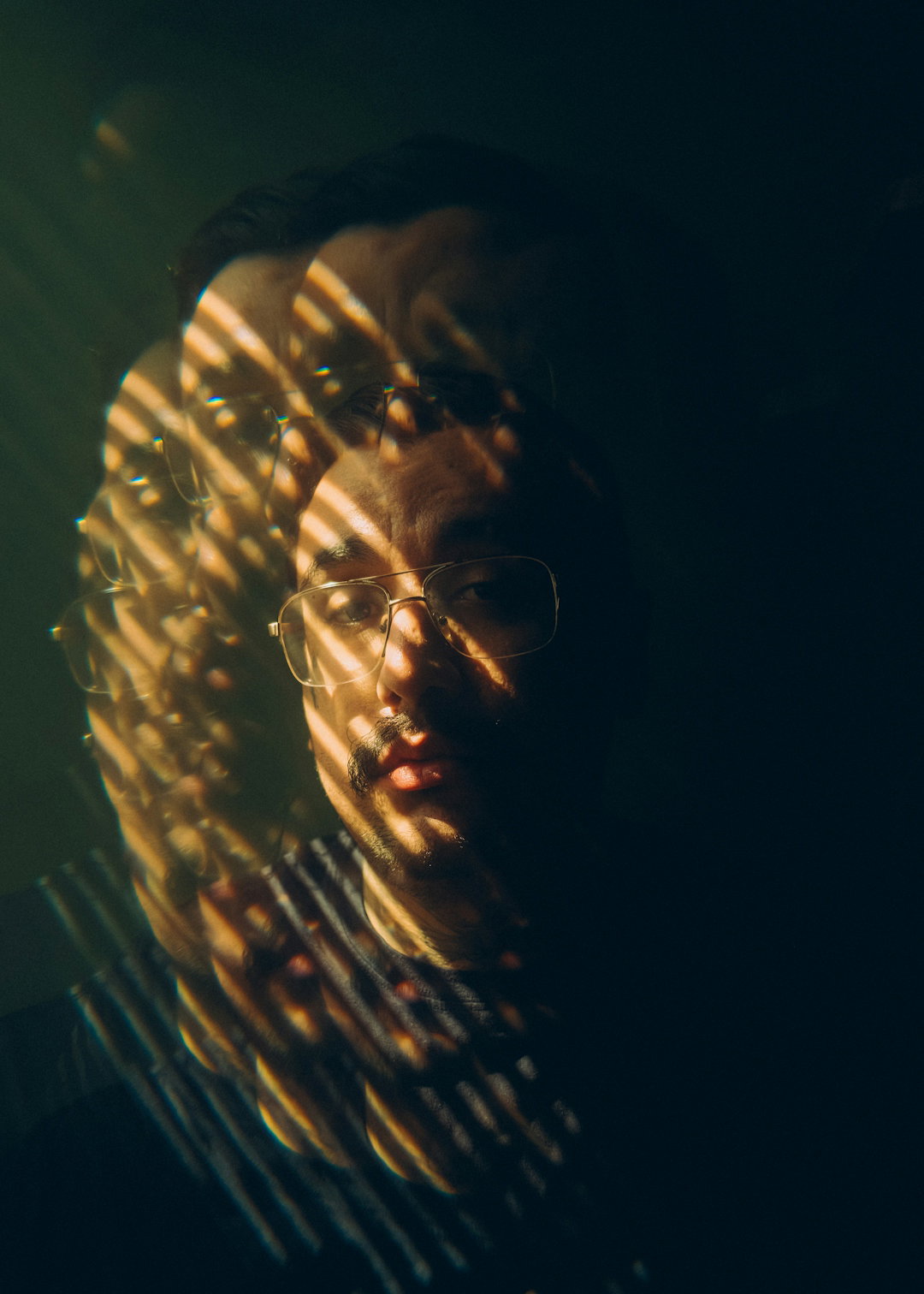 Multiple exposure portrait of a person with dramatic light streaks.